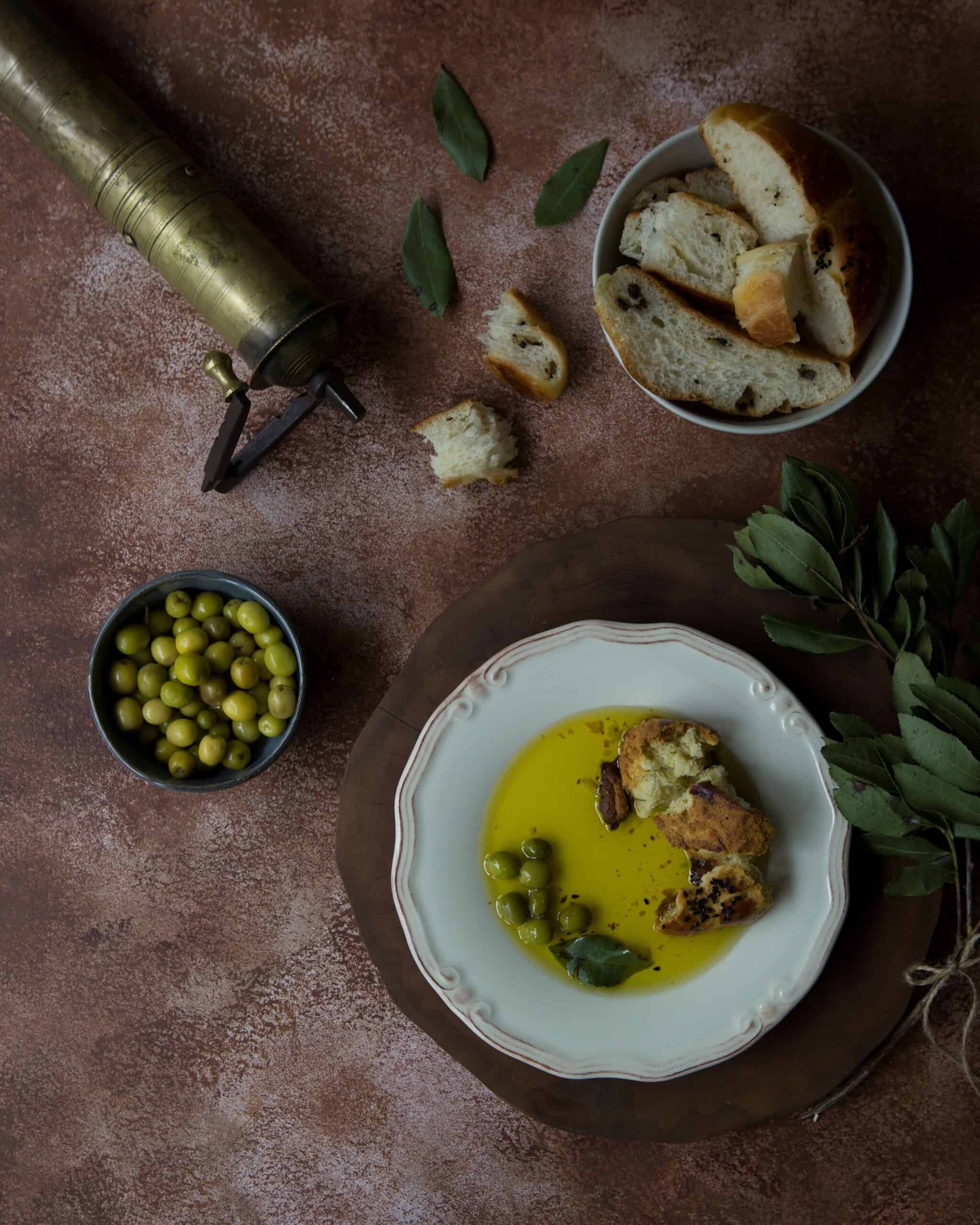 Delicious Mediterranean appetizer plated with olive oil and bread on a rustic setting.